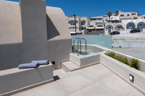 a rooftop patio with a swimming pool on a building at White Orchid Boutique Apartments in Vóthon