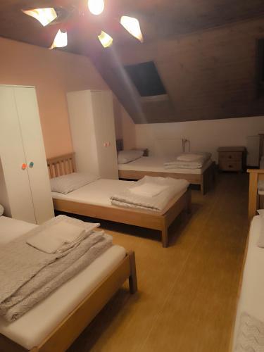 a room with three beds and a ceiling with lights at Lydiana Ubytování in Vysoké Mýto