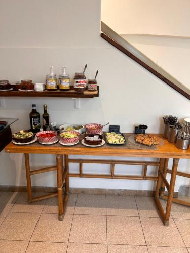 a table with many plates of food on it at Hotel Lukas Vegetarian & Vegan in Viareggio