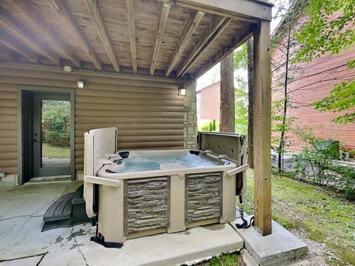 an outdoor hot tub sitting on a patio at Peytons Hideaway in Gatlinburg