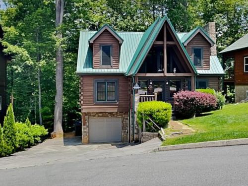 a house with a green roof and a garage at Peytons Hideaway in Gatlinburg