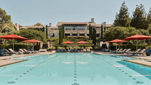 a large swimming pool with chairs and umbrellas at Rosewood Sand Hill in Menlo Park