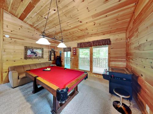 a pool table in a room with wooden walls at Peytons Hideaway in Gatlinburg