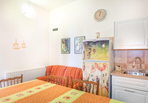 a kitchen with two tables and a refrigerator at Oasi Verde in Castiglione Chiavarese