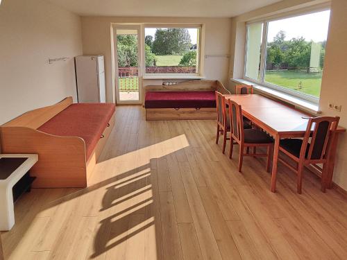 a room with a bedroom with a table and a bed at Degučiai ,svečių namai in Šakiai