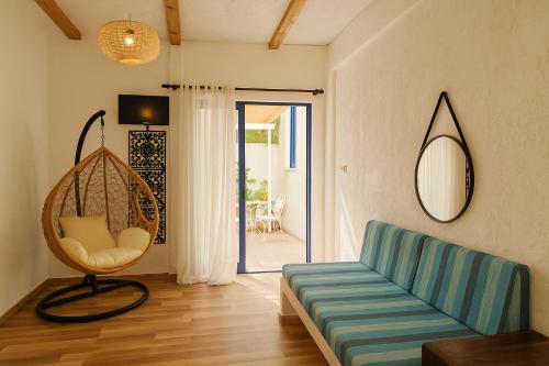 a living room with a blue couch and a mirror at BF Blue Cactus in Agia Pelagia