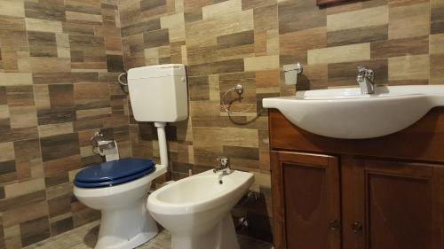 a bathroom with a toilet and a sink at Casolare La Torre in Scopello