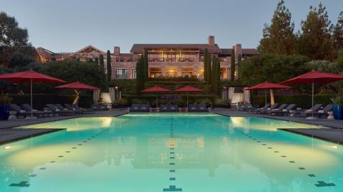 a large swimming pool with chairs and umbrellas at Rosewood Sand Hill in Menlo Park
