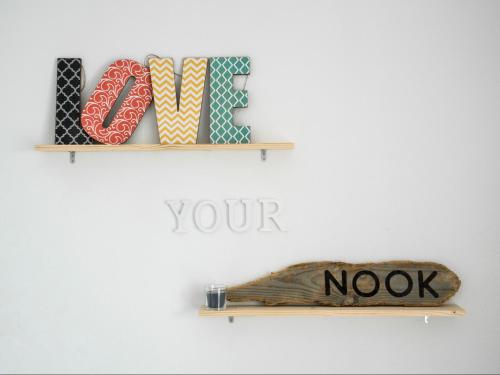 a shelf with cookies and a sign on a wall at Nooks Apartment in Sintra