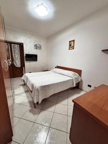 a bedroom with a bed and a television in it at L' oasi del Riposo in Teana