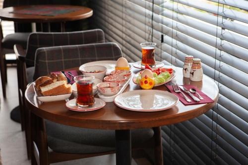 a table with food and bread and drinks on it at The Abies in Canakkale