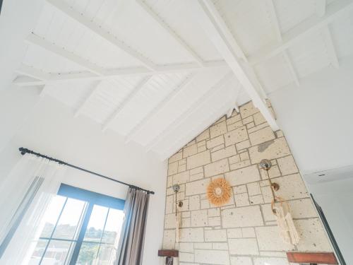 una stanza con un muro di mattoni e una finestra di Blanco a Çeşme