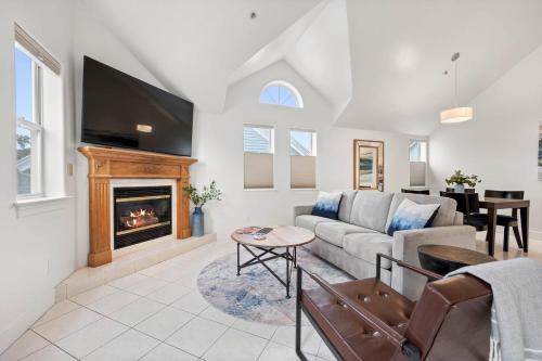 a living room with a couch and a fireplace at Mavericks Penthouse Downtown Luxury on Main Street Half Moon Bay in Half Moon Bay