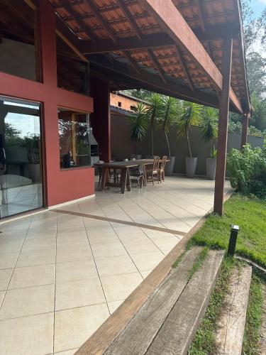 an outdoor patio with a table and chairs at Casa ampla e confortável in Cotia