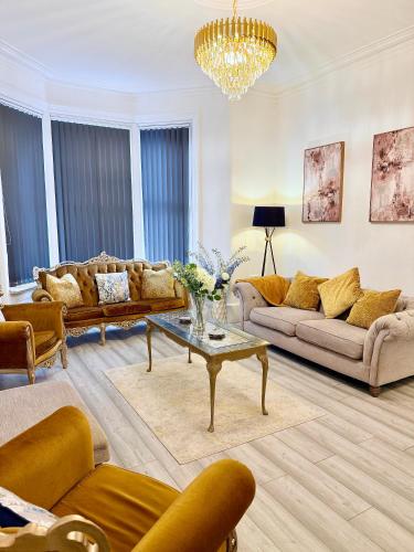 a living room with couches and a coffee table at Vance Holiday Home in Blackpool