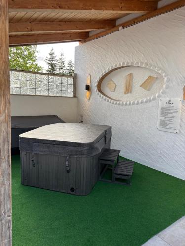 a room with a bed and two chairs in a building at REMA Homes - Jacuzzi Terrasse 55' TV Küche Regendusche in Bad Bellingen