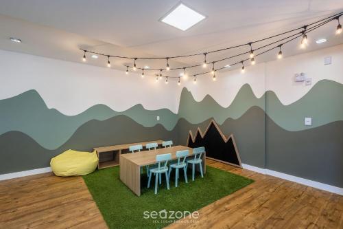 a dining room with a mountain mural on the wall at Condomínio a beira-mar c/ piscina - SHC in Piçarras