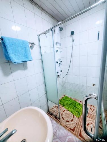 a bathroom with a shower with a toilet and a sink at Keba Guest House in Addis Ababa
