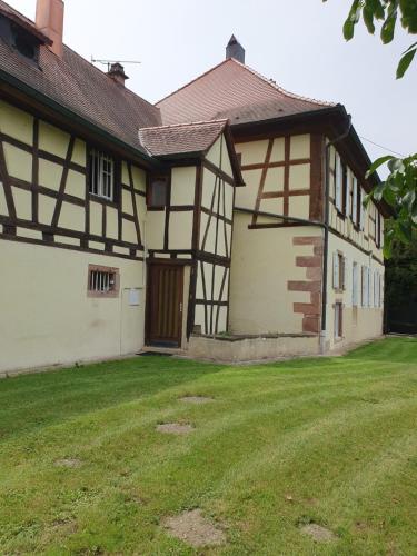 a house with a grass yard in front of it at Domaine d'Alémanie in Ebersmunster