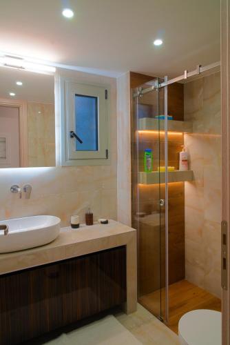 a bathroom with a sink and a glass shower at Keti's Elite in Athens