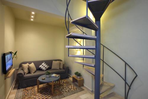 a spiral staircase in a living room with a couch at Dar Alma in Soûr