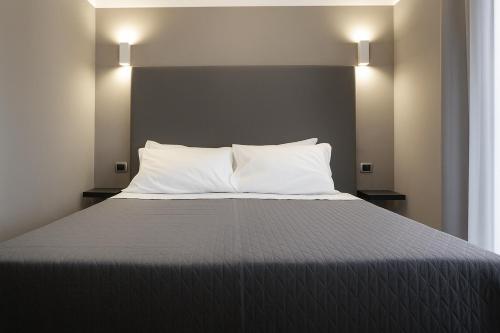 a bedroom with a bed with white pillows at Piazza Carità in Naples