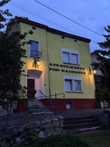 a building with a sign on the side of it at Apartamenty Pod Kalwarią Góra Św Anny in Góra Świętej Anny