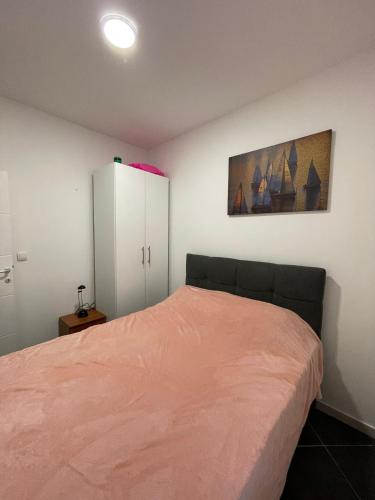 a bedroom with a bed and a white cabinet at Apartman Drinsko Srce in Bratunac