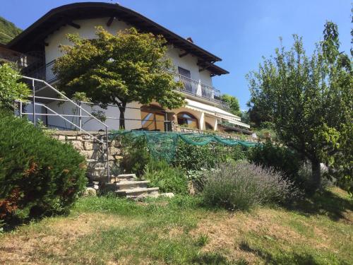 a house on a hill with stairs in front of it at Casa Vacanza SK in Bianzano