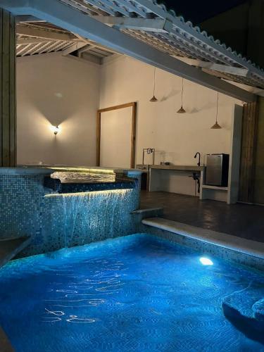 a large swimming pool with blue water in a room at CASA con alberca, súper ubicación. Puerto de Veracruz in Veracruz