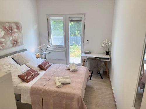 a bedroom with a bed with two towels on it at Villa Luna in Ervenik