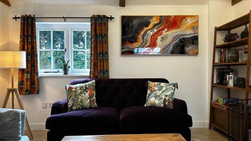 a living room with a couch and a window at Annexe Orchard Cottage in Mersham
