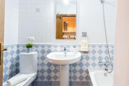 a bathroom with a sink and a toilet at Apartamento Las Cruces 3 in Gijón