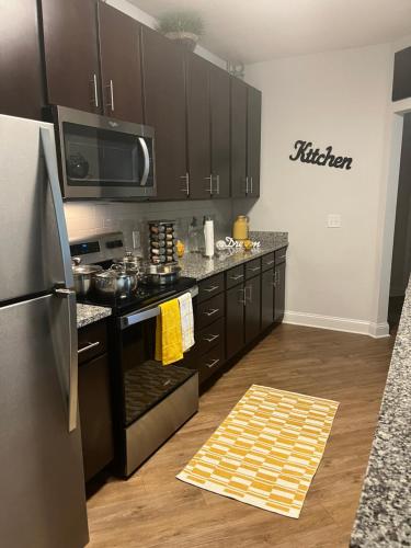 a kitchen with black cabinets and a stainless steel refrigerator at 500 East Apartments in Daytona Beach