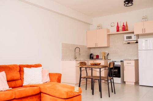 a living room with a couch and a table at Ocean Mist Suites in Arnos Vale