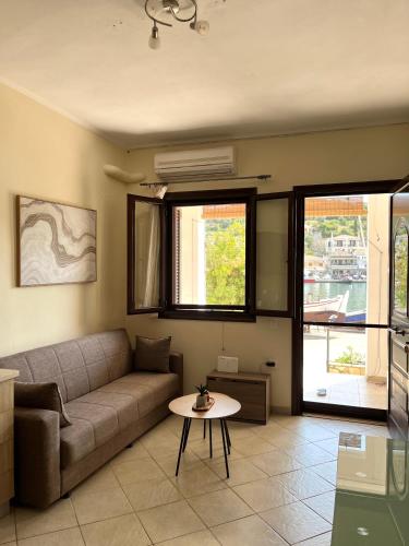 a living room with a couch and a table at Vathi Seaside Apartment in Meganisi