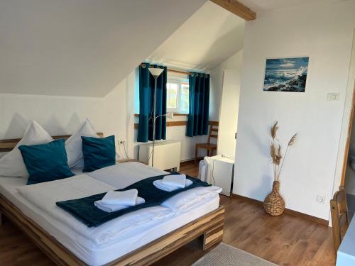 a bedroom with a large bed with blue pillows at Pensiunea Andra in Jurilovca