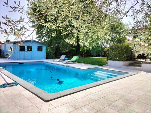 une piscine avec de l'eau bleue dans une cour dans l'établissement Maison d'Alex, à Bon-Encontre