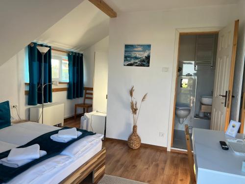 a bedroom with a bed and a desk in it at Pensiunea Andra in Jurilovca