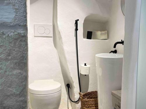 a bathroom with a toilet and a sink at Luxe Studio with Jacuzzi, Ostuni Center in Ostuni