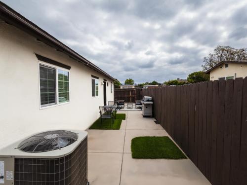 a small backyard with a fence and a heater at Exotic Home Escondido 3 Bedroom by sdstay in Escondido