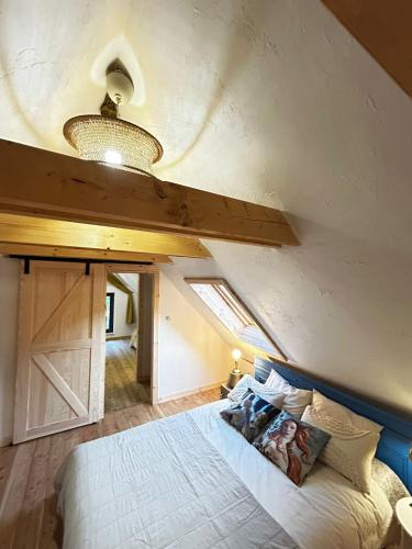 a bedroom with a bed and a ceiling with a window at Szumidomki strefa z jacuzzi sauna widok na potok las in Zawoja
