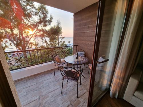 a balcony with a table and chairs and the ocean at Dreamland Oasis in Chakvi in Chakvi