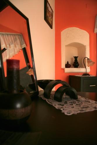 a room with a desk with a mirror and a lamp at Stou Kir Yianni in Omodos