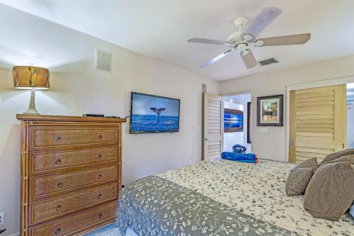 Schlafzimmer mit einem Bett, einer Kommode und einem Deckenventilator in der Unterkunft Puamana 160-4 Premium Oceanfront in Lahaina
