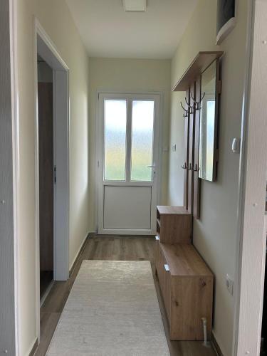 a hallway with a door and a stairwell with a mirror at Kuća Pod Brezama 