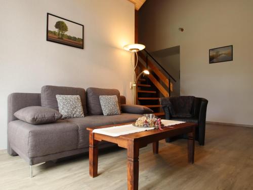 a living room with a couch and a coffee table at Reihenhäuser in Strackholt in Strackholt