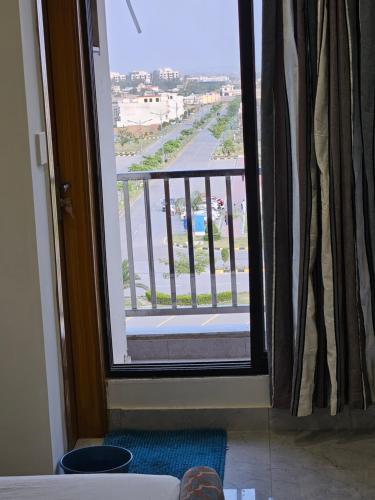 a door to a balcony with a view of a street at StayNova - Transit Apartment near Motorways & Airport in Islamabad