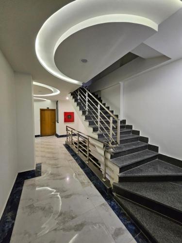 a hallway with stairs in an office building at StayNova - Transit Apartment near Motorways & Airport in Islamabad