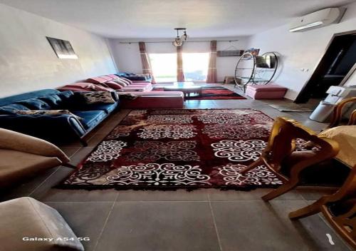 a living room with a couch and a rug at فرصة نادرةشاليه أرضي بجاردن oفي أرقى مواقع زون Q in El Alamein